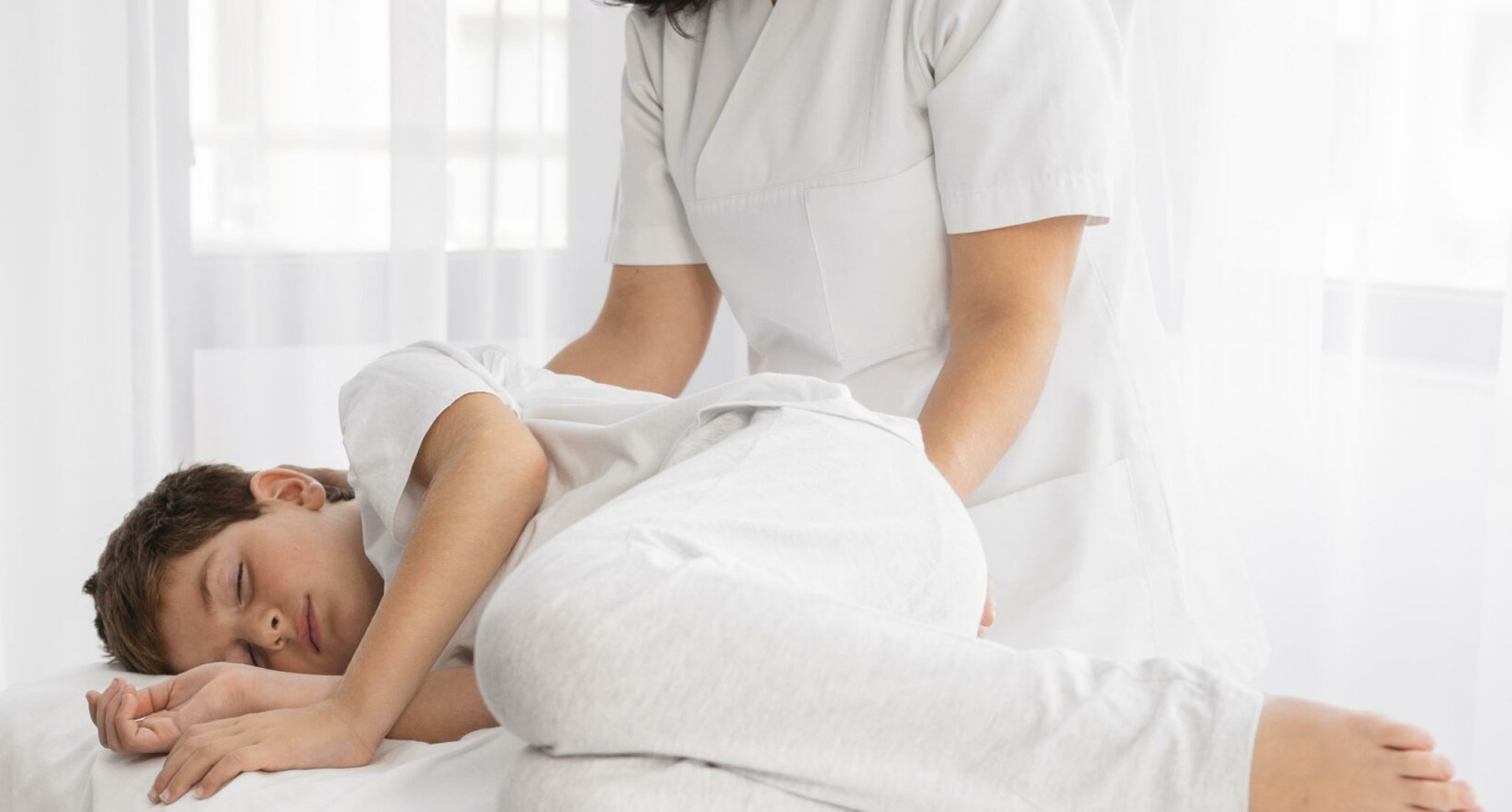female-osteopathist-treating-kid-hospital
